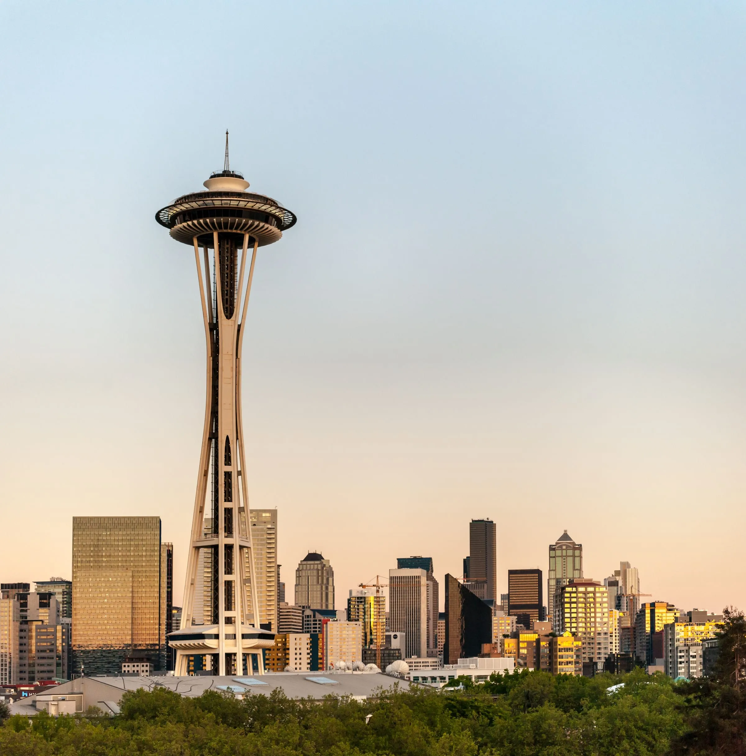 The Seattle skyline at golden hour, the Space Needle rising above it.