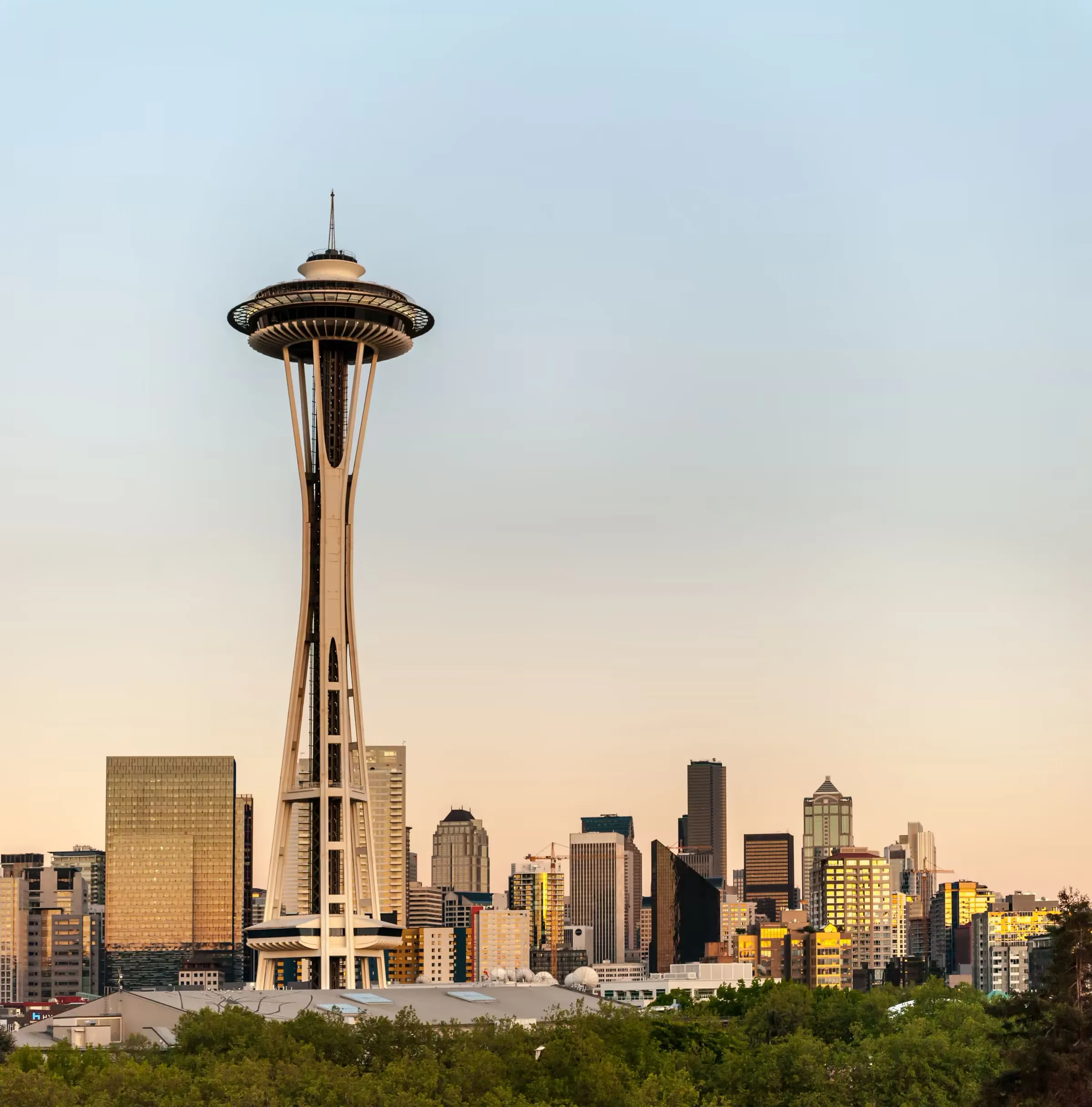 The Seattle skyline at golden hour, the Space Needle rising above it.
